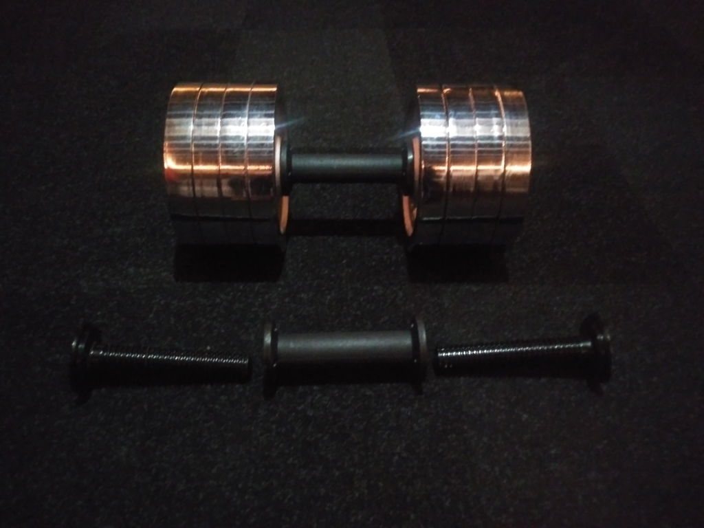 A plate loaded dumbbell handle carrying chrome plates, above a second handle taken apart to show its longer threaded posts