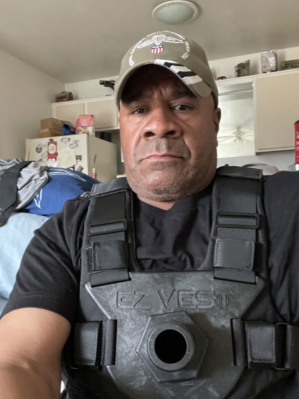 An owner at home wearing the vest, its chest mount sitting flat and centred