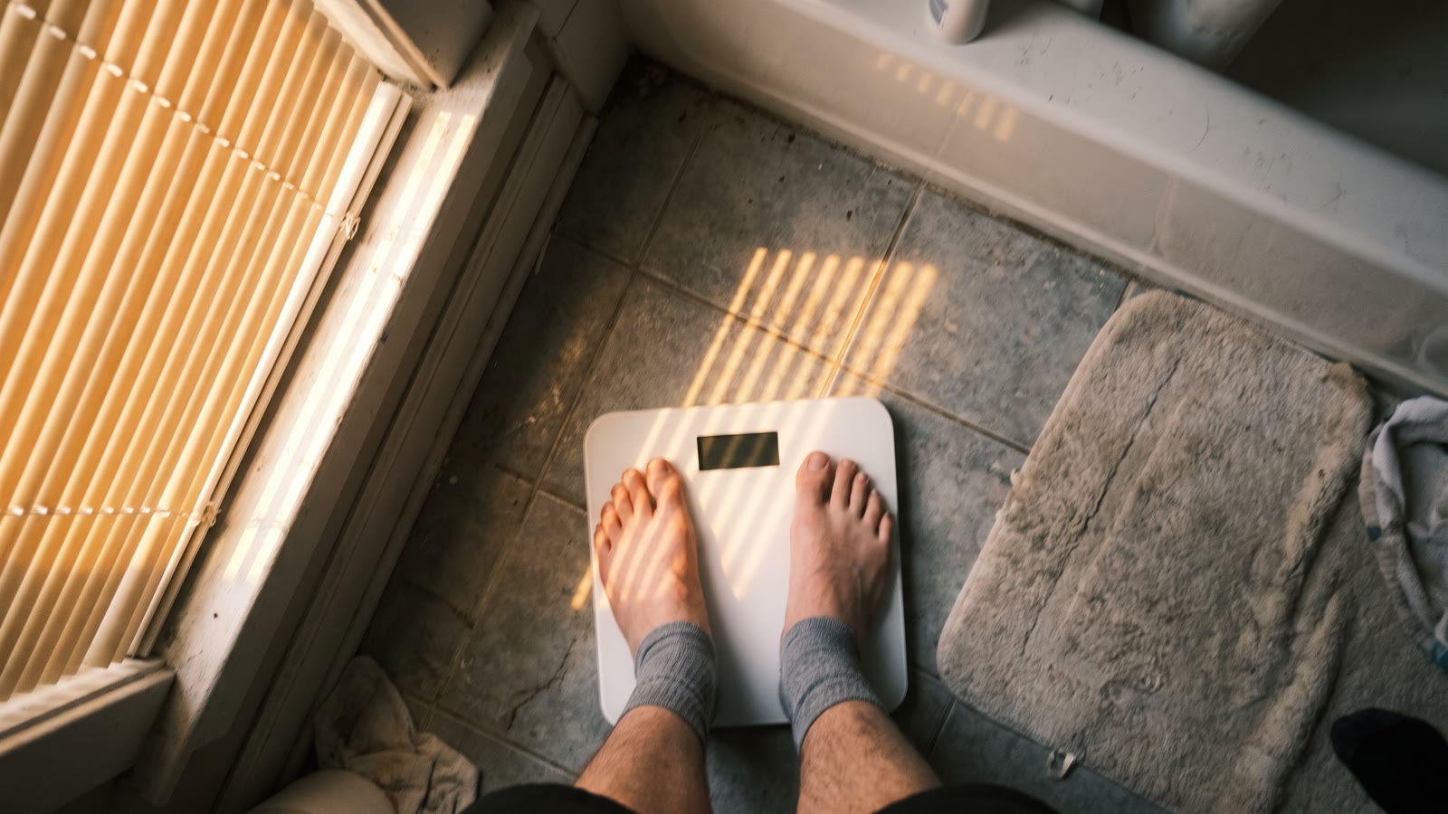 Bare feet on a bathroom scale in early morning light